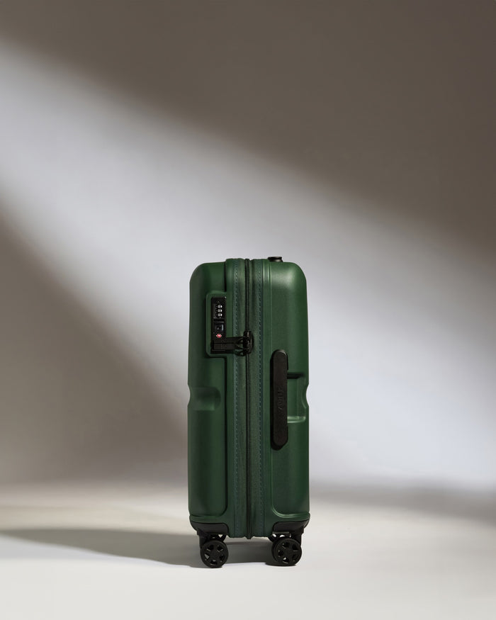 a green suitcase with wheels