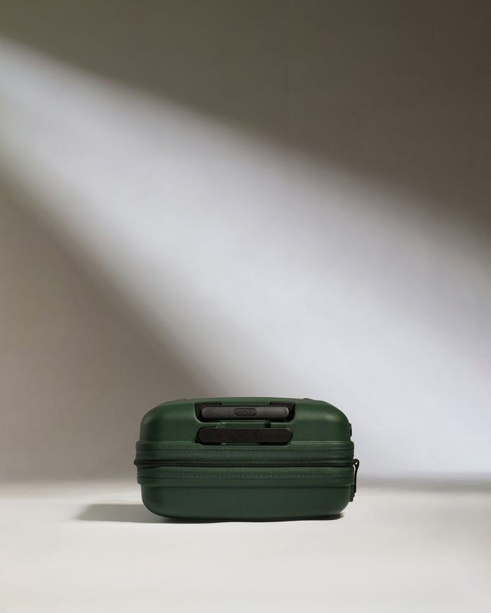 a green suitcase with a zipper