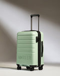 a light green suitcase with wheels