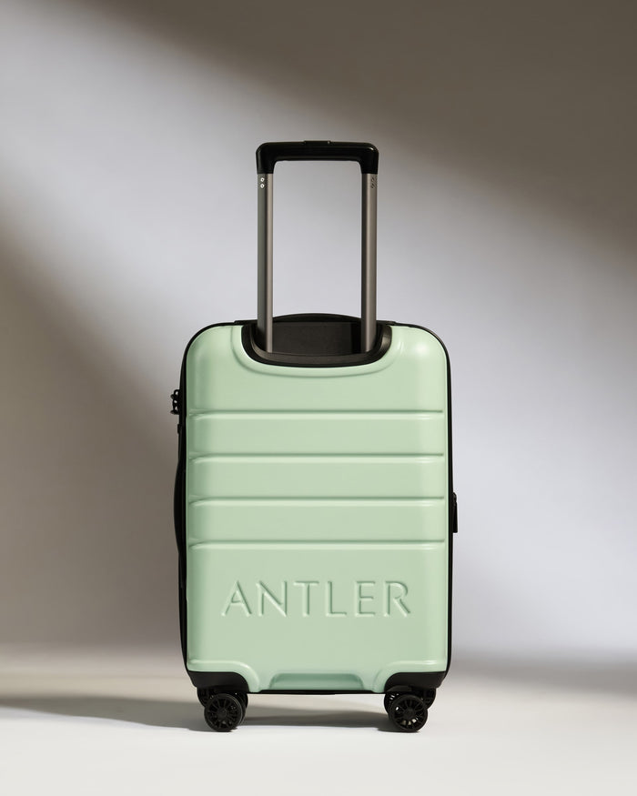 a green suitcase with handle