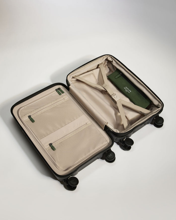 a suitcase with wheels and a green object