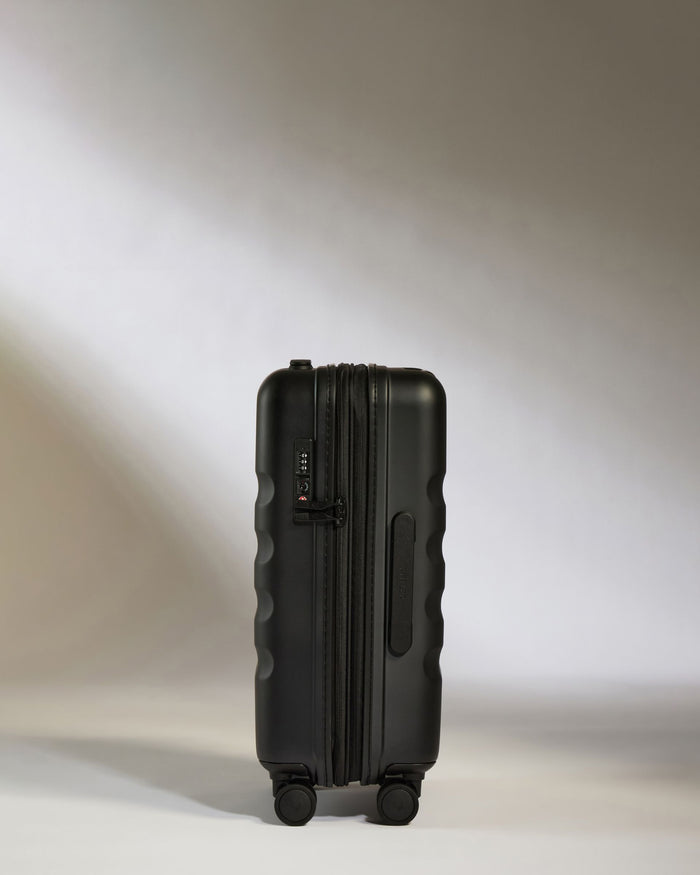 a black suitcase on a white surface