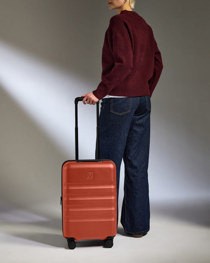 a person standing with a suitcase