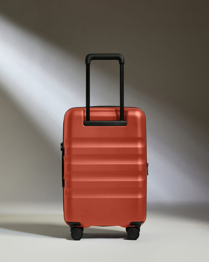 a red suitcase with black wheels