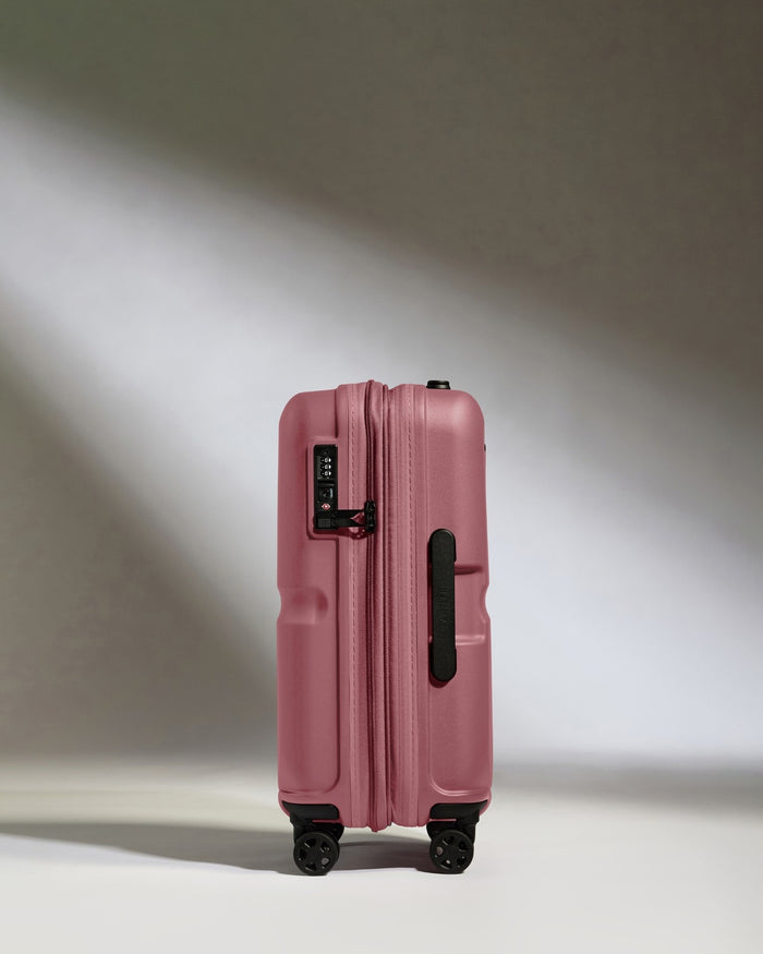 a pink suitcase with wheels