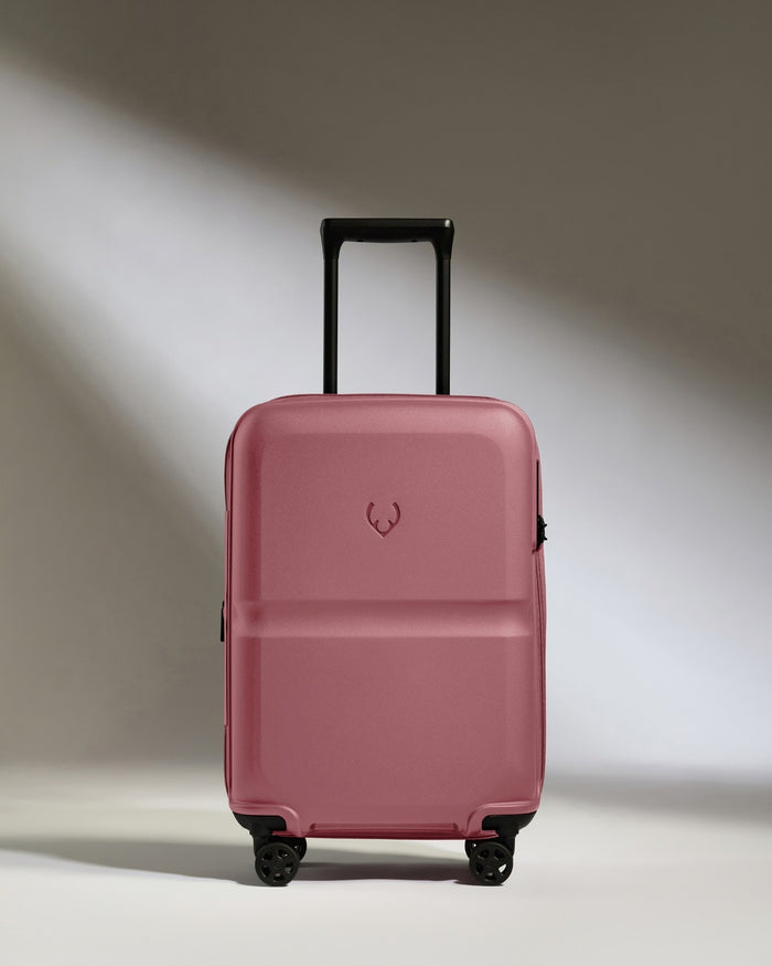 a pink suitcase with wheels