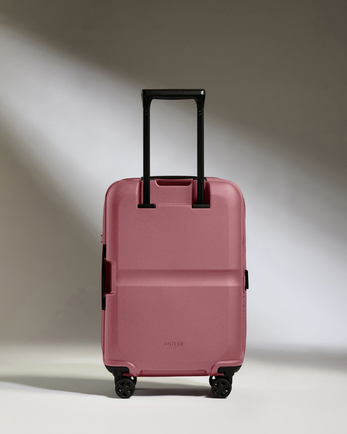 a pink suitcase with wheels