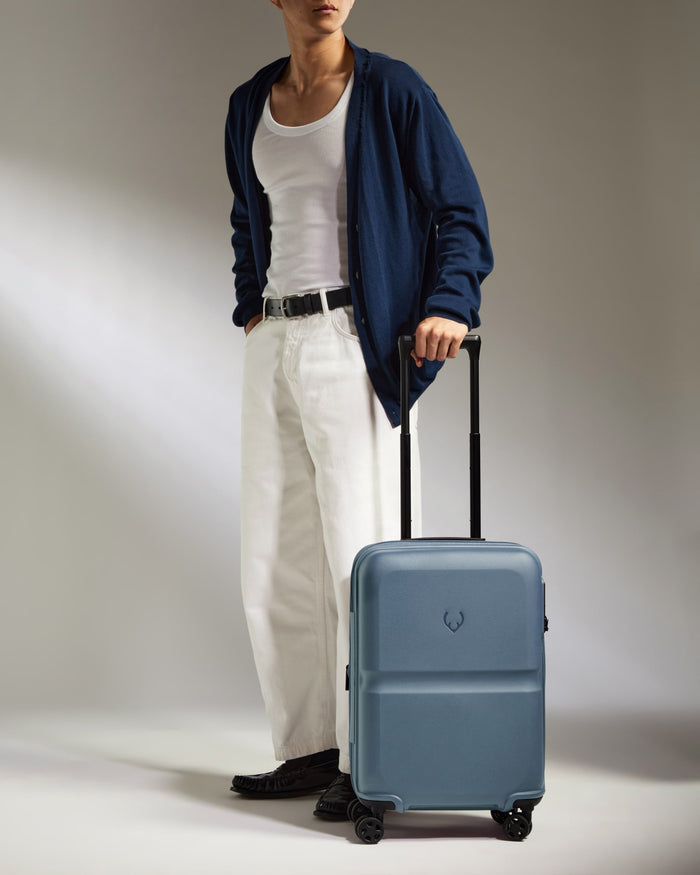 a man standing with a suitcase