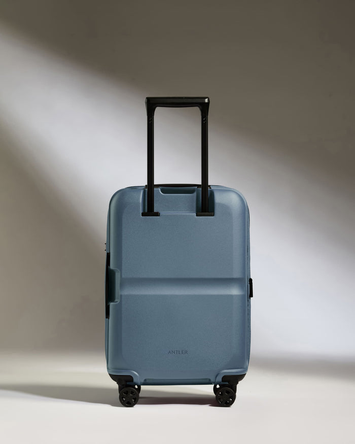 a blue suitcase with black wheels