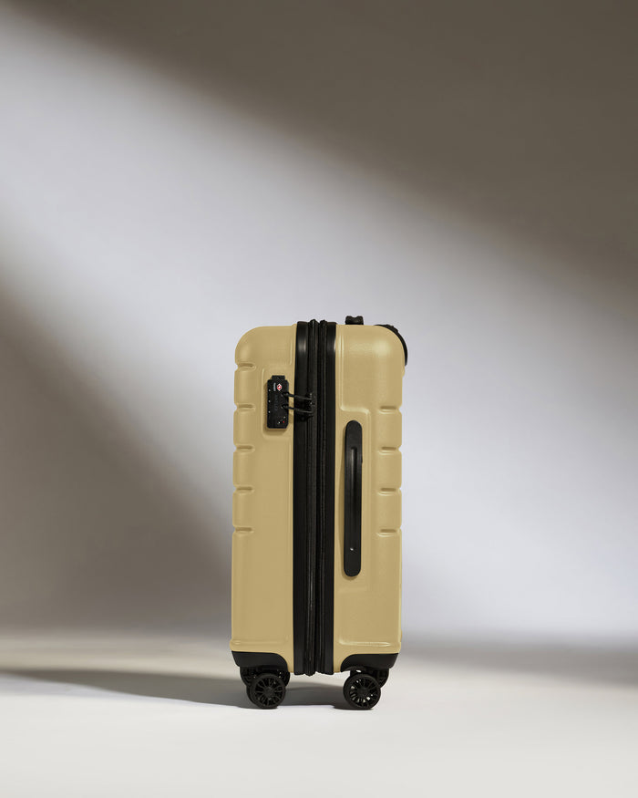 a tan suitcase with wheels