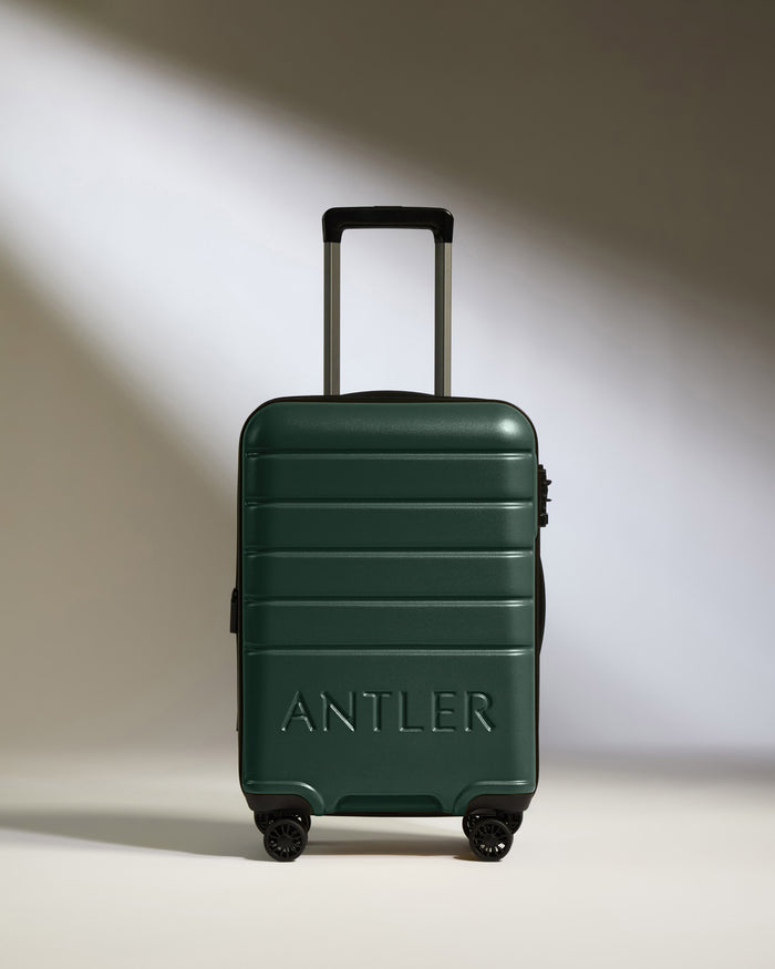 a green suitcase with wheels