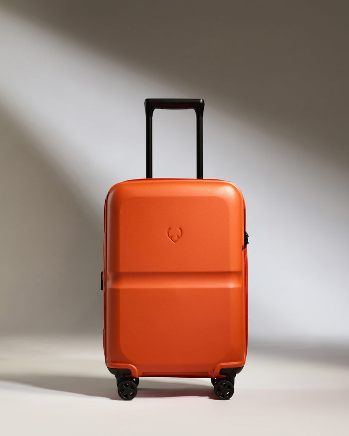 an orange suitcase with wheels