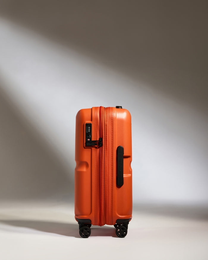 an orange suitcase with wheels