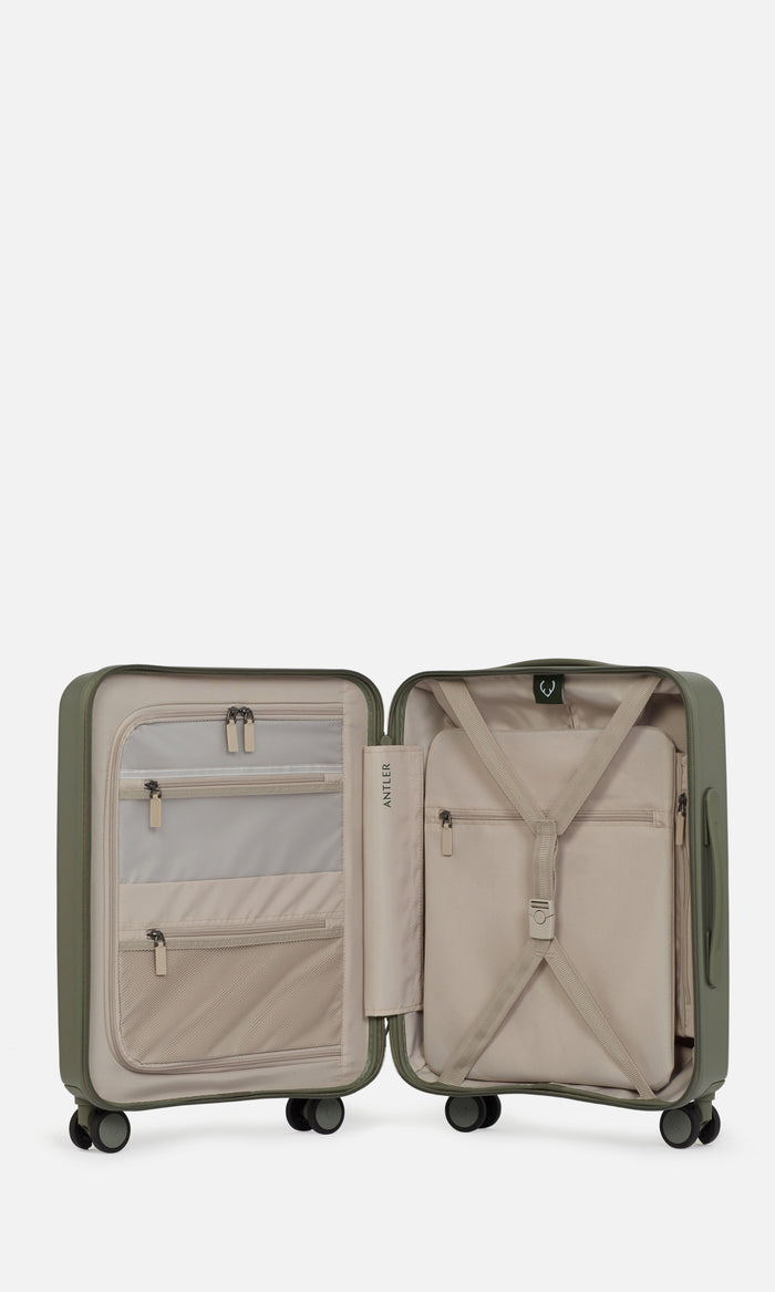 a green suitcase with zippers and pockets