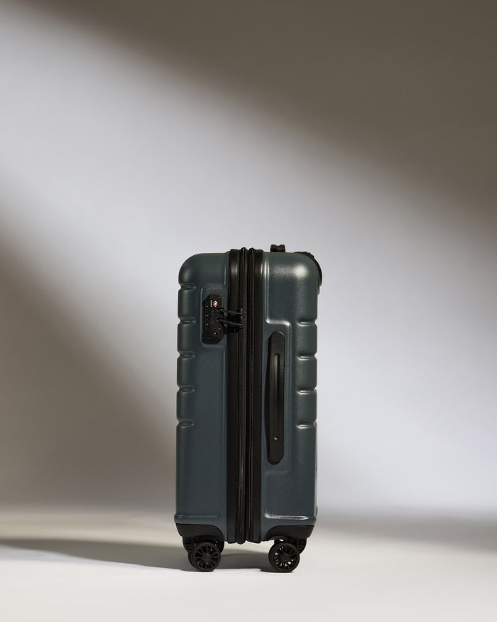 a suitcase on wheels with a light on the side