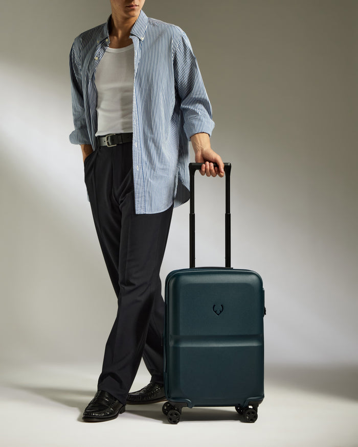 a man standing with a suitcase