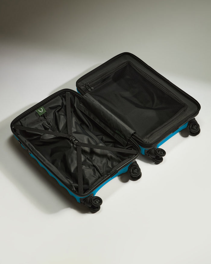 a blue and black suitcase with wheels