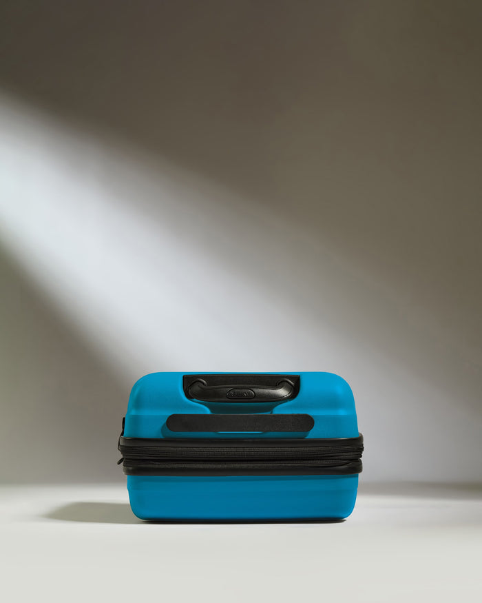 a blue suitcase with a black handle