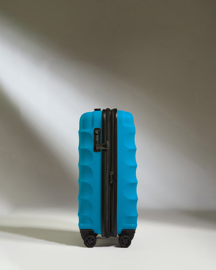 a blue suitcase with wheels
