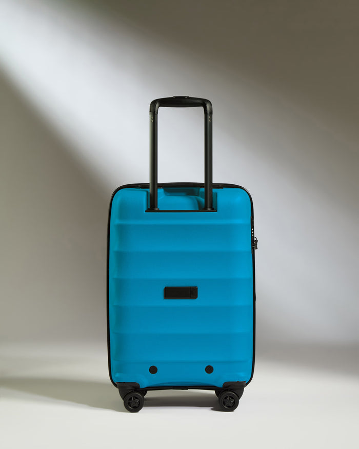 a blue suitcase with black handles