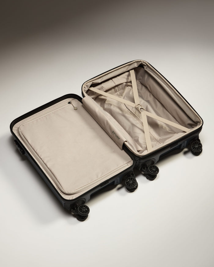 a suitcase with wheels and a tan cover