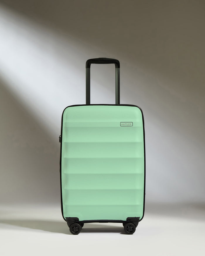 a green suitcase with wheels