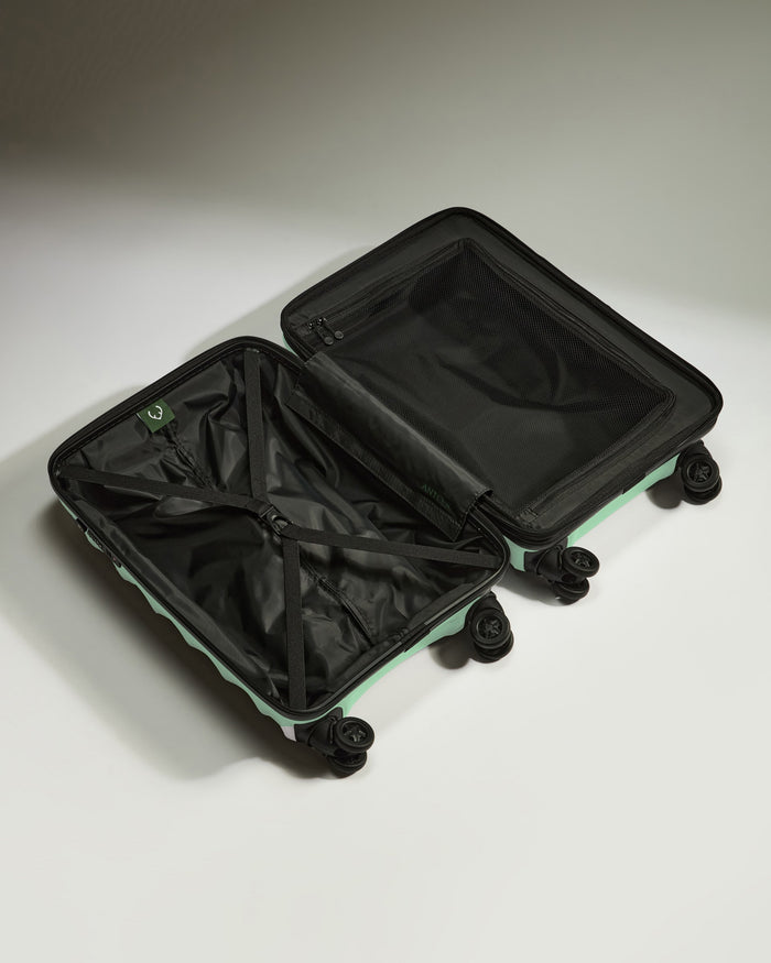 a black and green suitcase with wheels