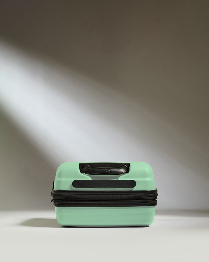 a light shining through a green suitcase