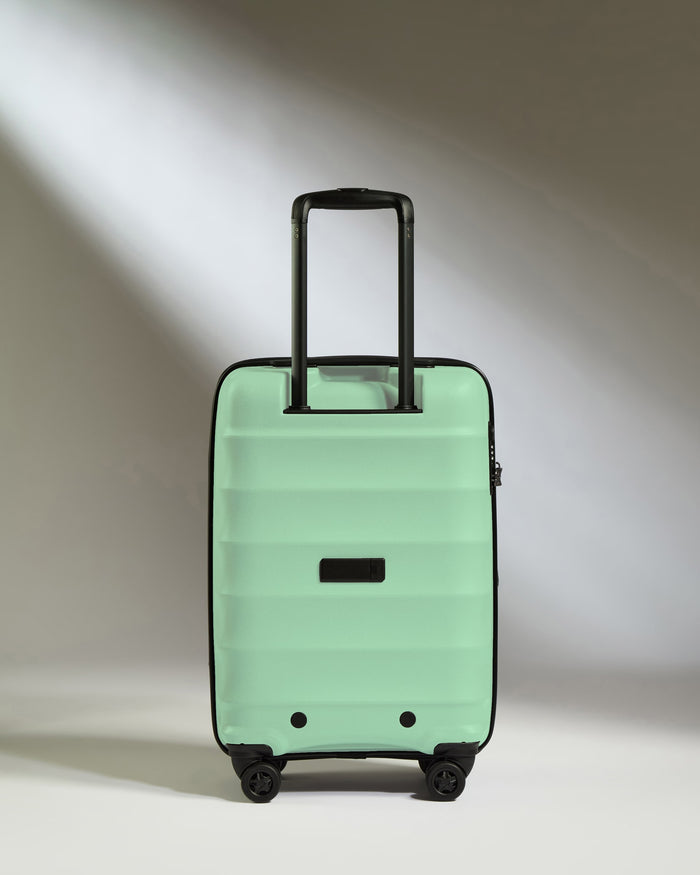 a green suitcase with black wheels