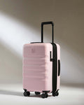 a pink suitcase with wheels
