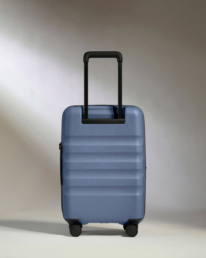a blue suitcase with black wheels