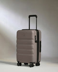 a grey suitcase with wheels