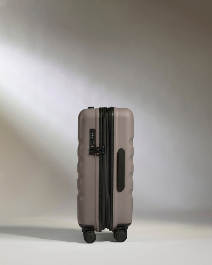 a grey suitcase with wheels