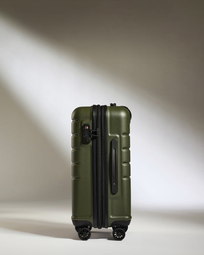 a green suitcase with wheels