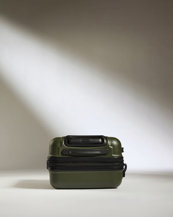 a green suitcase with a zipper
