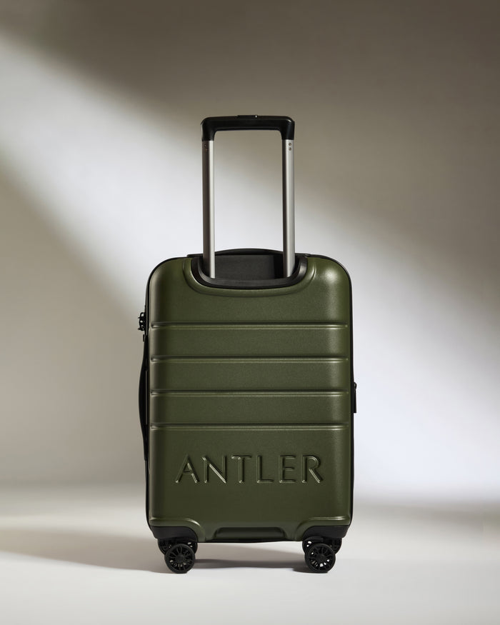 a green suitcase with handle