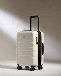 a white suitcase with black wheels