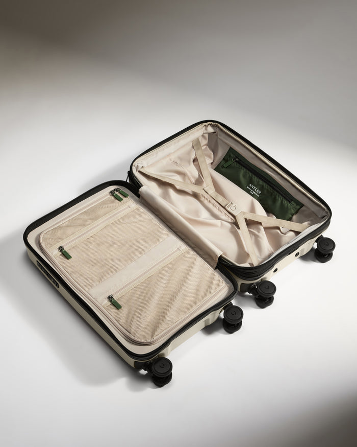 a suitcase with wheels and a green bag
