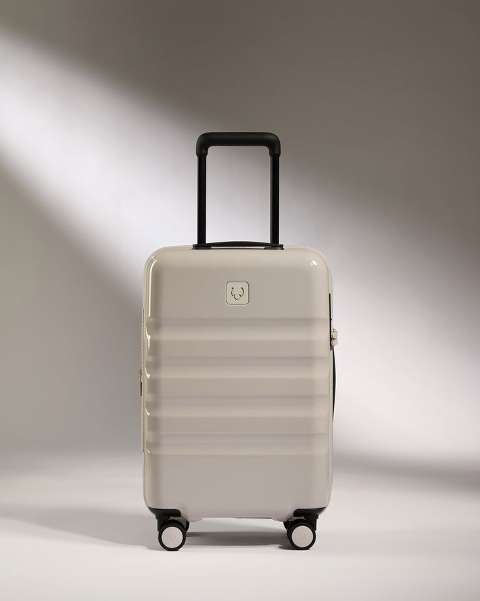 a white suitcase with black wheels