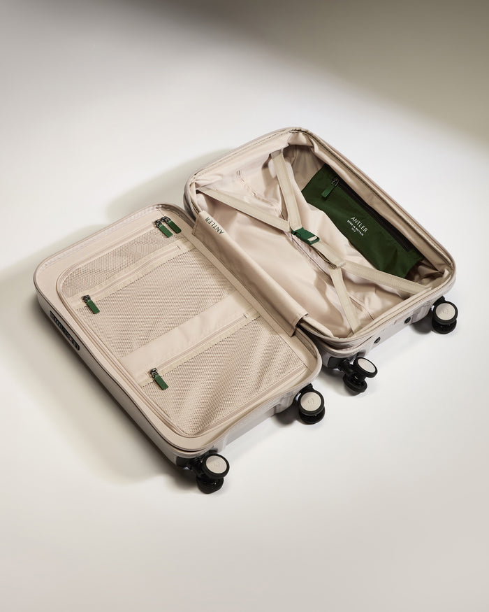 a suitcase with wheels and a green bag