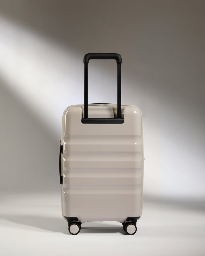 a white suitcase with black handles