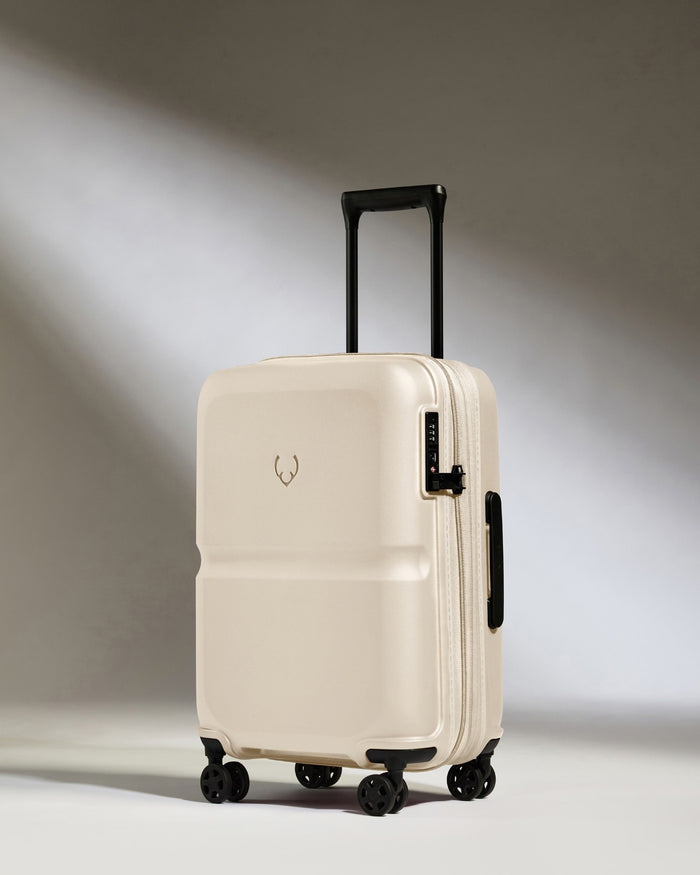 a white suitcase with black wheels