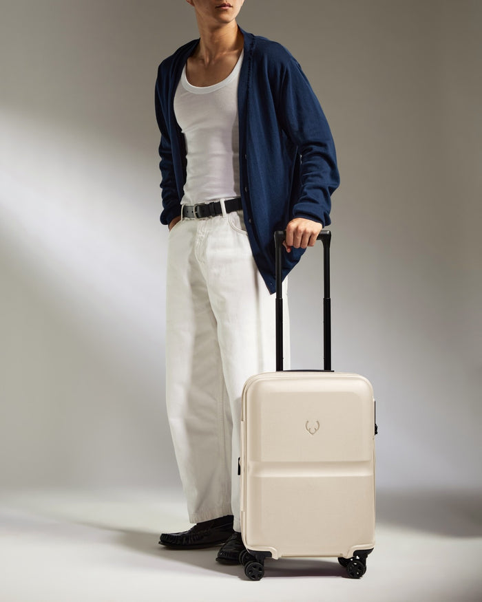 a man standing with a suitcase