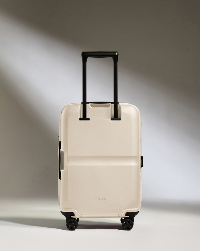 a white suitcase with black wheels