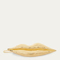 A gold metallic lips-shaped hair  clip with a textured, hammered finish, shown against a solid off-white background.