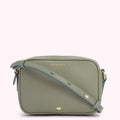 Sage green Lulu Guinness crossbody bag with a light teal shoulder strap and gold hardware.