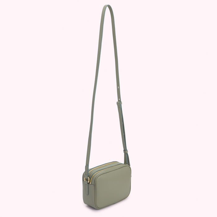 Sage green leather crossbody bag with gold zippers.