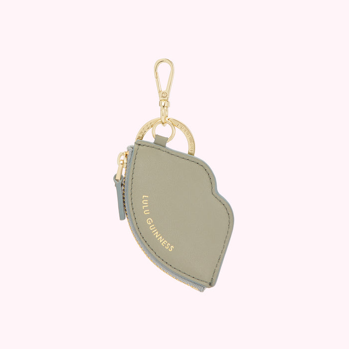 Sage green lip-shaped Lulu Guinness zip coin purse keychain with gold-tone hardware.