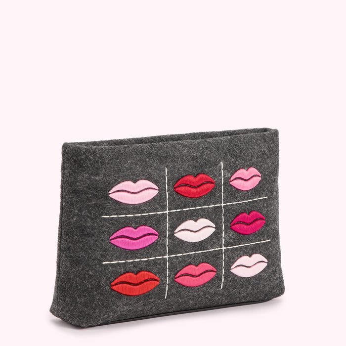 Gray felt cosmetic bag with embroidered lips in varying shades of pink and red.