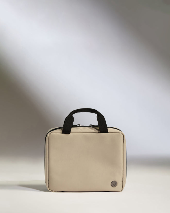 a small white bag with black handles